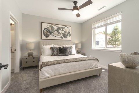 a bedroom with a bed and a ceiling fan